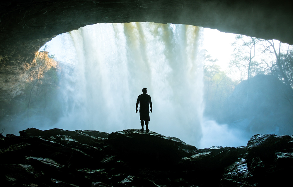 man at waterfall